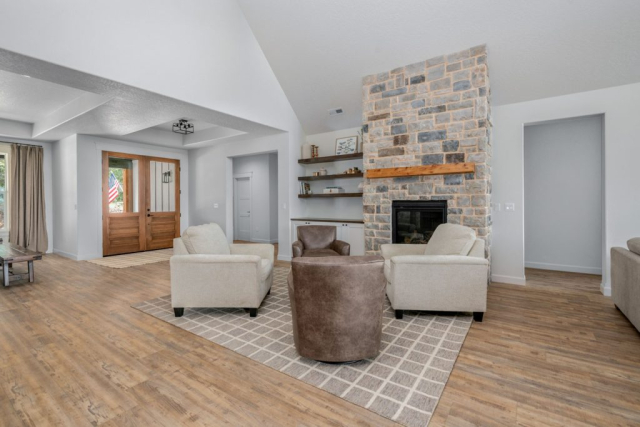 E Lisa Rd by Premier Quality Homes Living room with stone fireplace and built in shelves