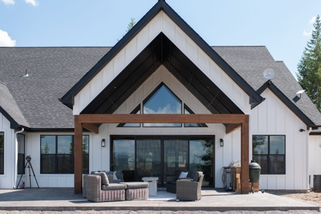 Entryway of home with tall pitched gable roof